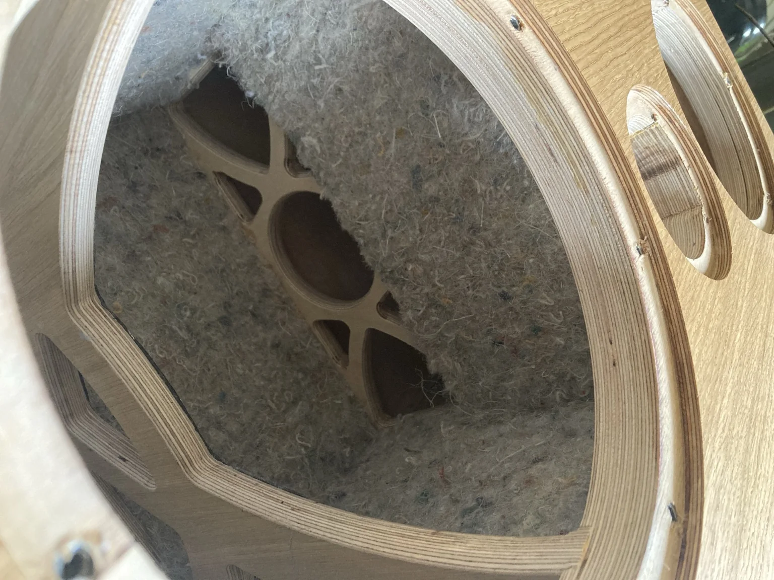 View through a Cwen driver opening showing arched plywood bracing and natural fibre lining